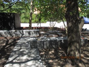 Stacked bluestone benches are a striking design feature as well as a functional place to sit in Camberwell garden designed by Melbourne garden designers Ian Barker Gardens