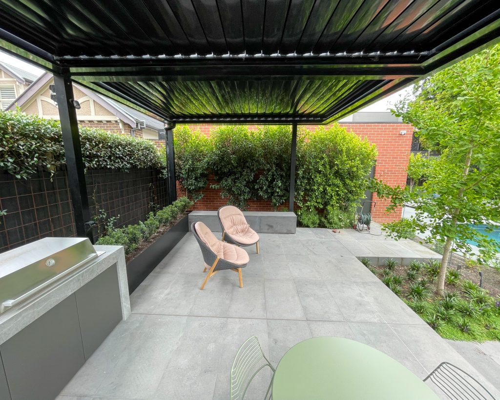 A landscape design by Ian Barker Gardens, including the a Louvre roof. A fixed or retractable Louvre roof changes an entertaining area from a fair-weather amenity into something closer to another room of the house.
